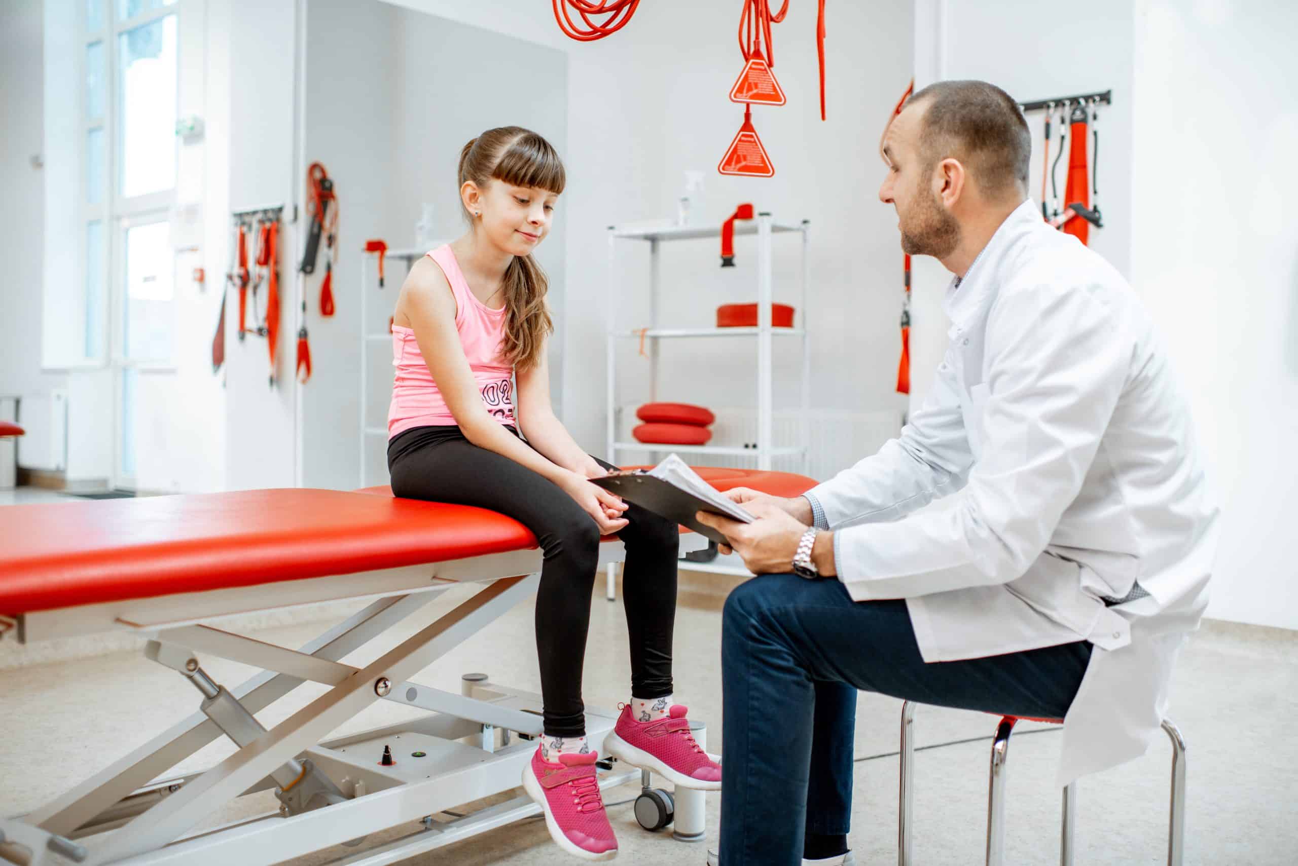 Sports physio undergoing medical consultation at the rehabilitation clinic with suspension medical equipment