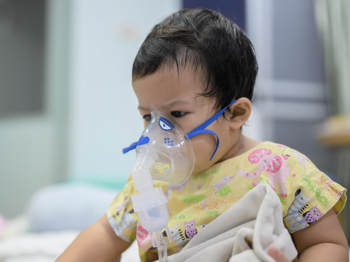 A baby receives respiratory syncytial virus treatment at a pediatric clinic.