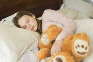 sleeping girl with teddy bear