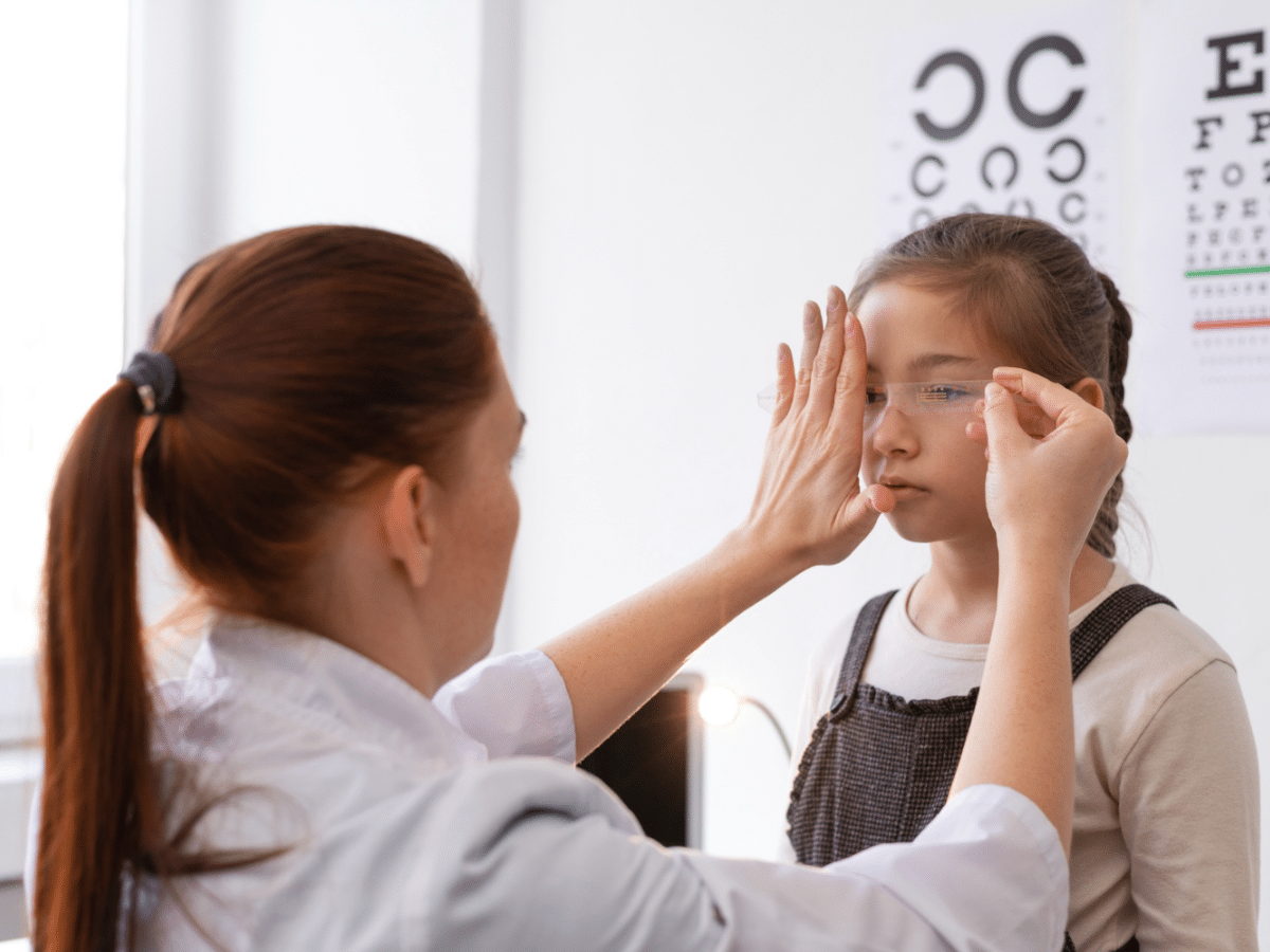 A pediatrician conducts a vision test on a child, as good vision is essential for most sports