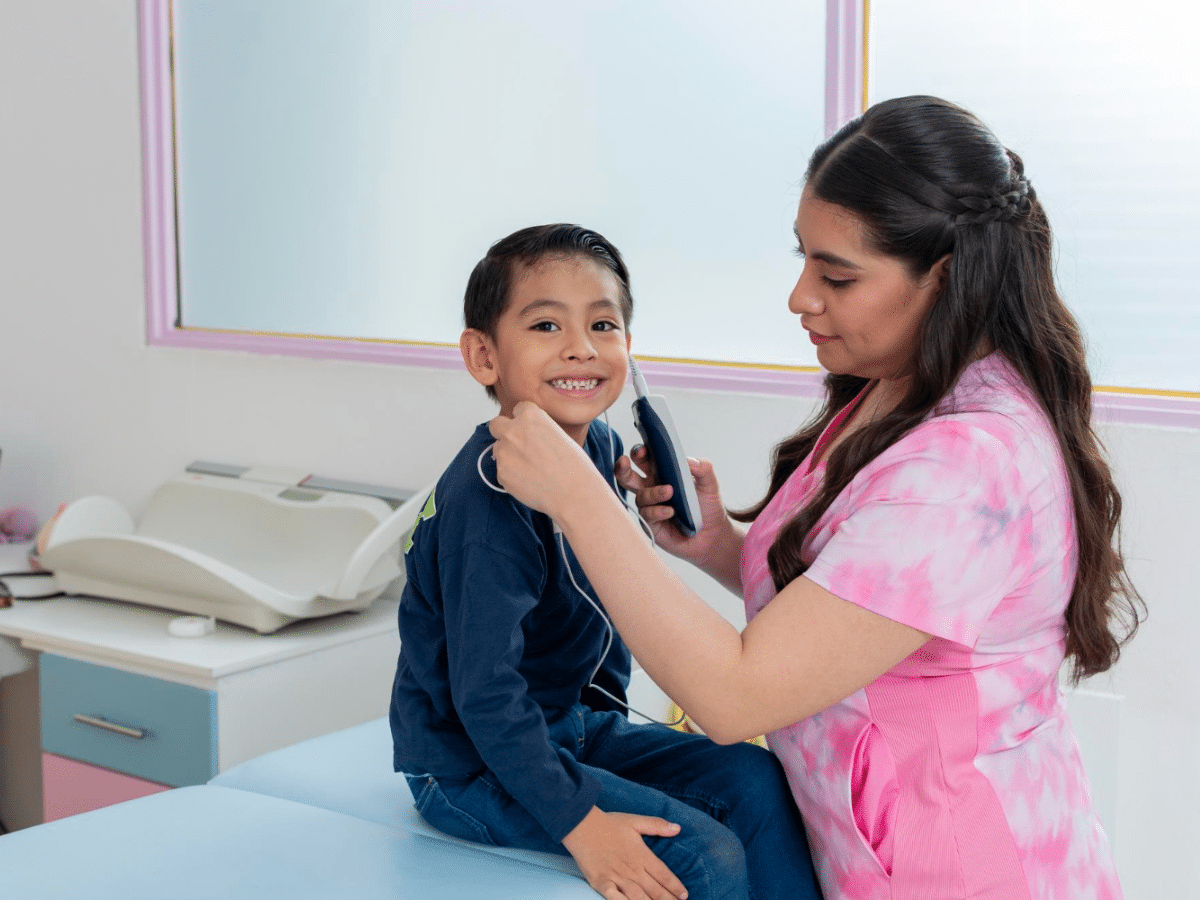 With culturally competent pediatric care, a boy undergoes a hearing screening in a comfortable environment.