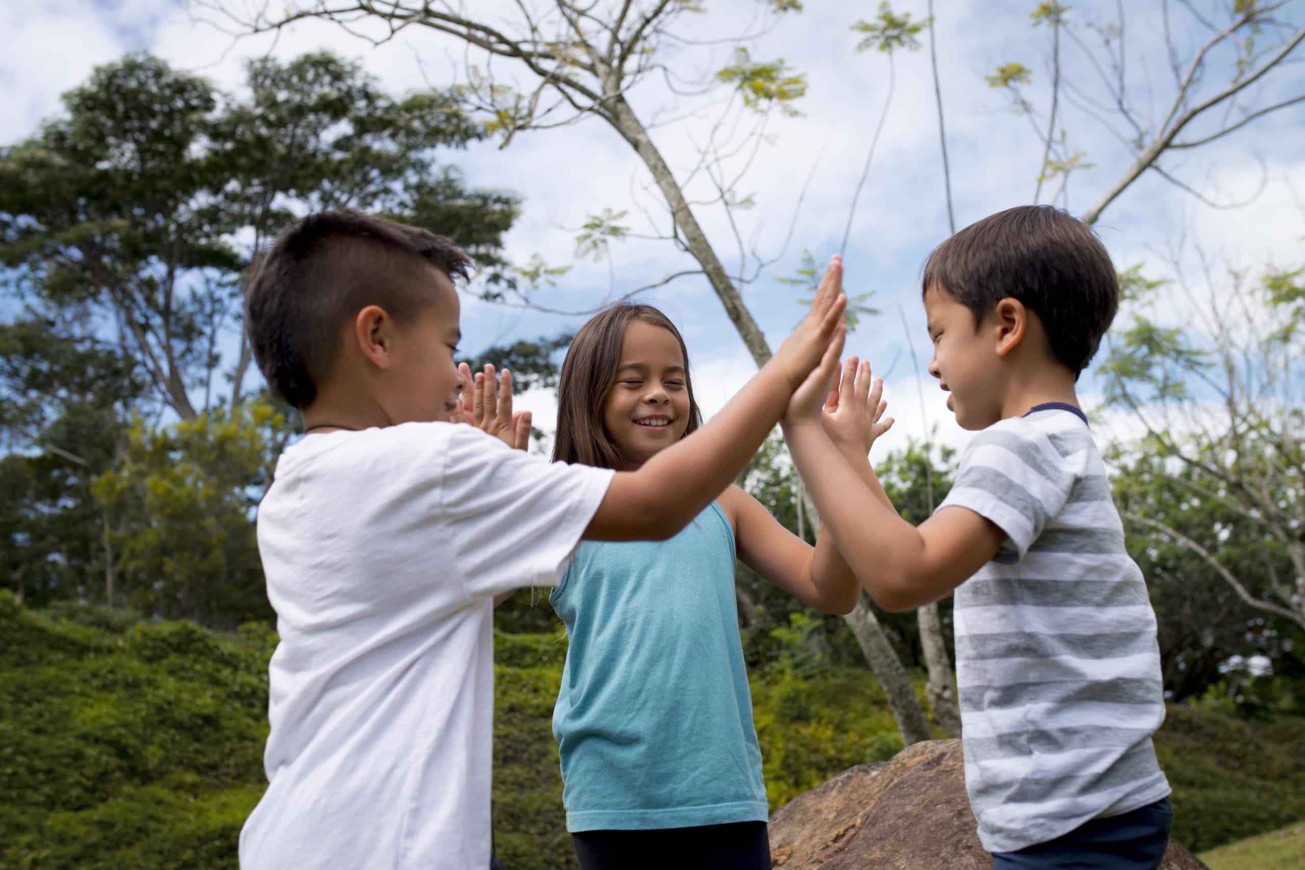 Three kids happily play outside, protected by the mumps vaccine they received from CMCFresno.