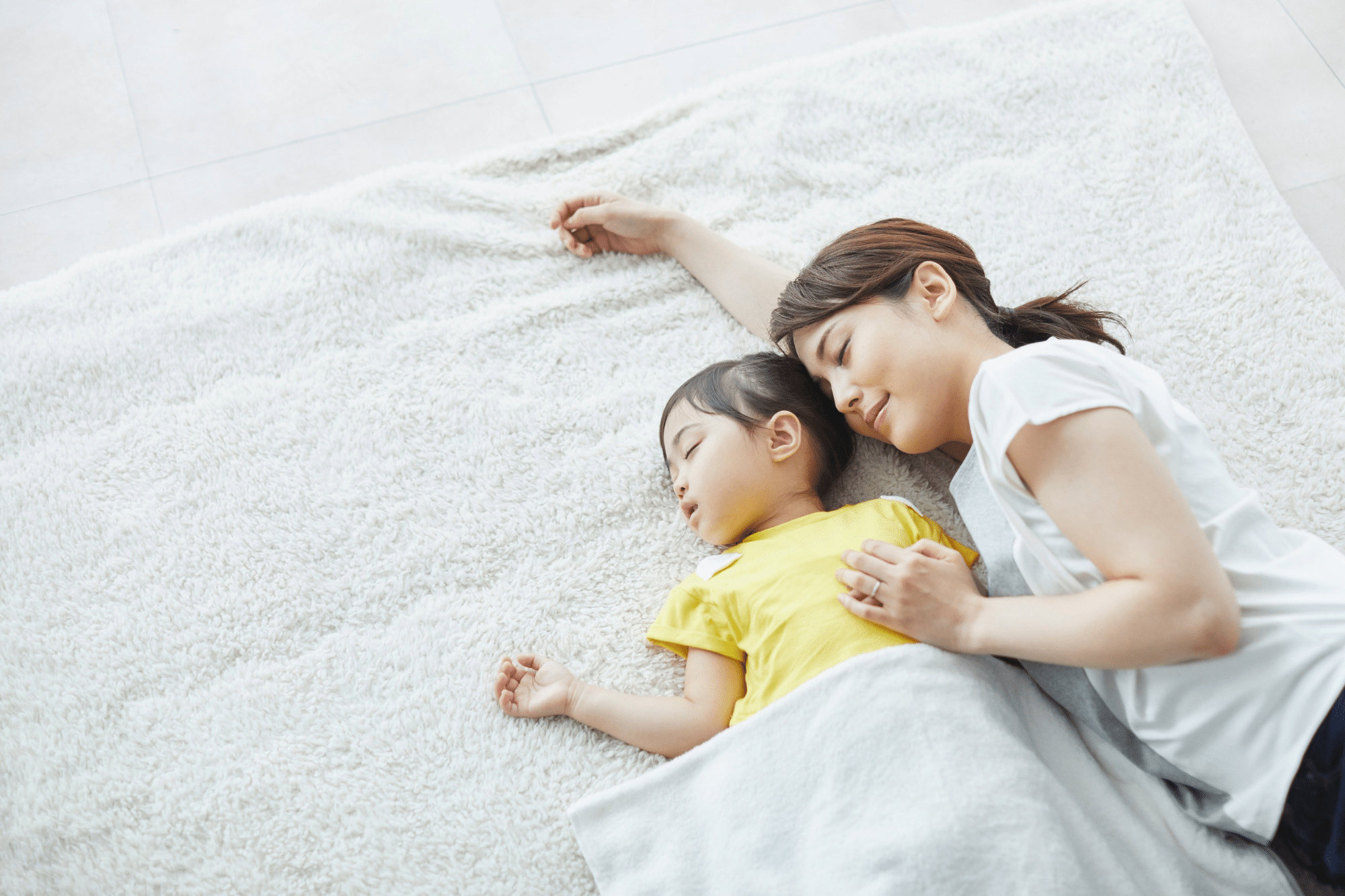 Mother and child resting together, reflecting healthy sleep patterns and peaceful bonding time.
