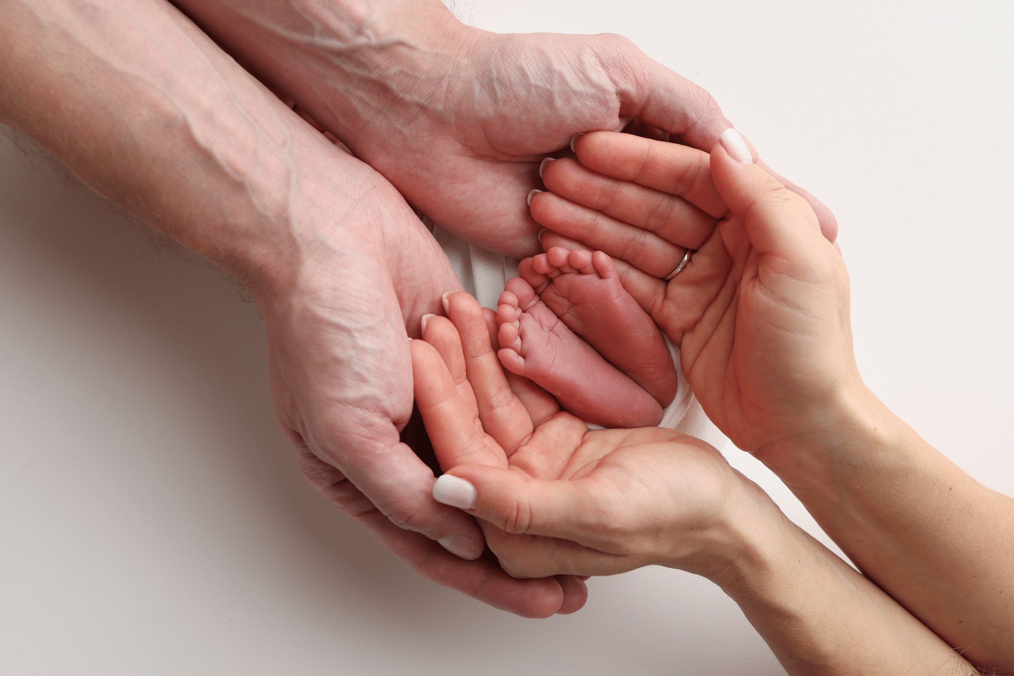 Two parents gently holding their premature baby together, showing warmth, protection, and compassionate infant care.