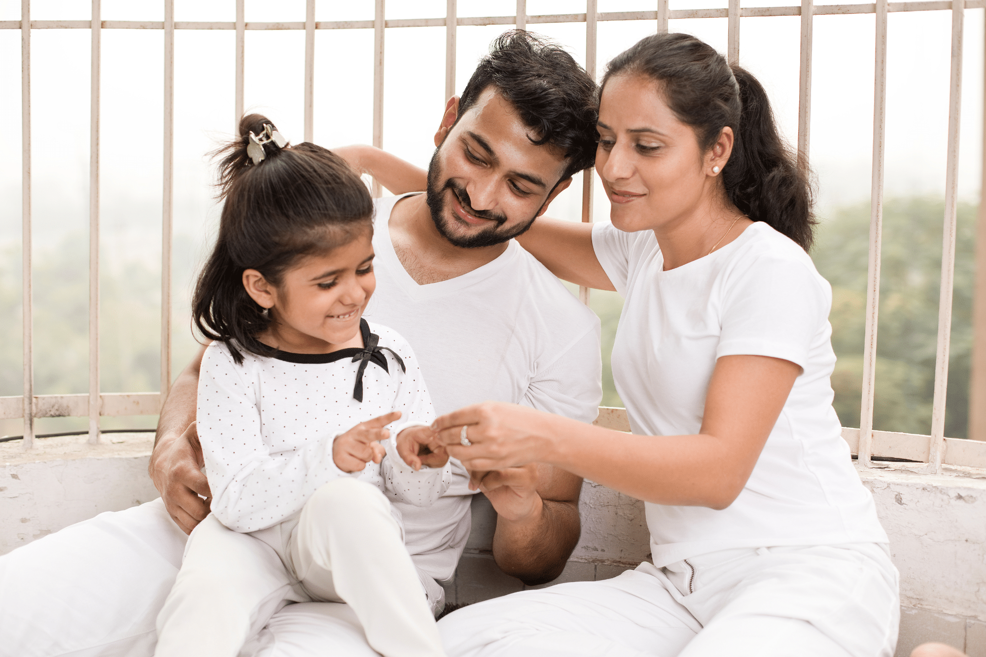 Parents happily playing with their daughter after she underwent effective pediatric treatment for her hormonal health condition