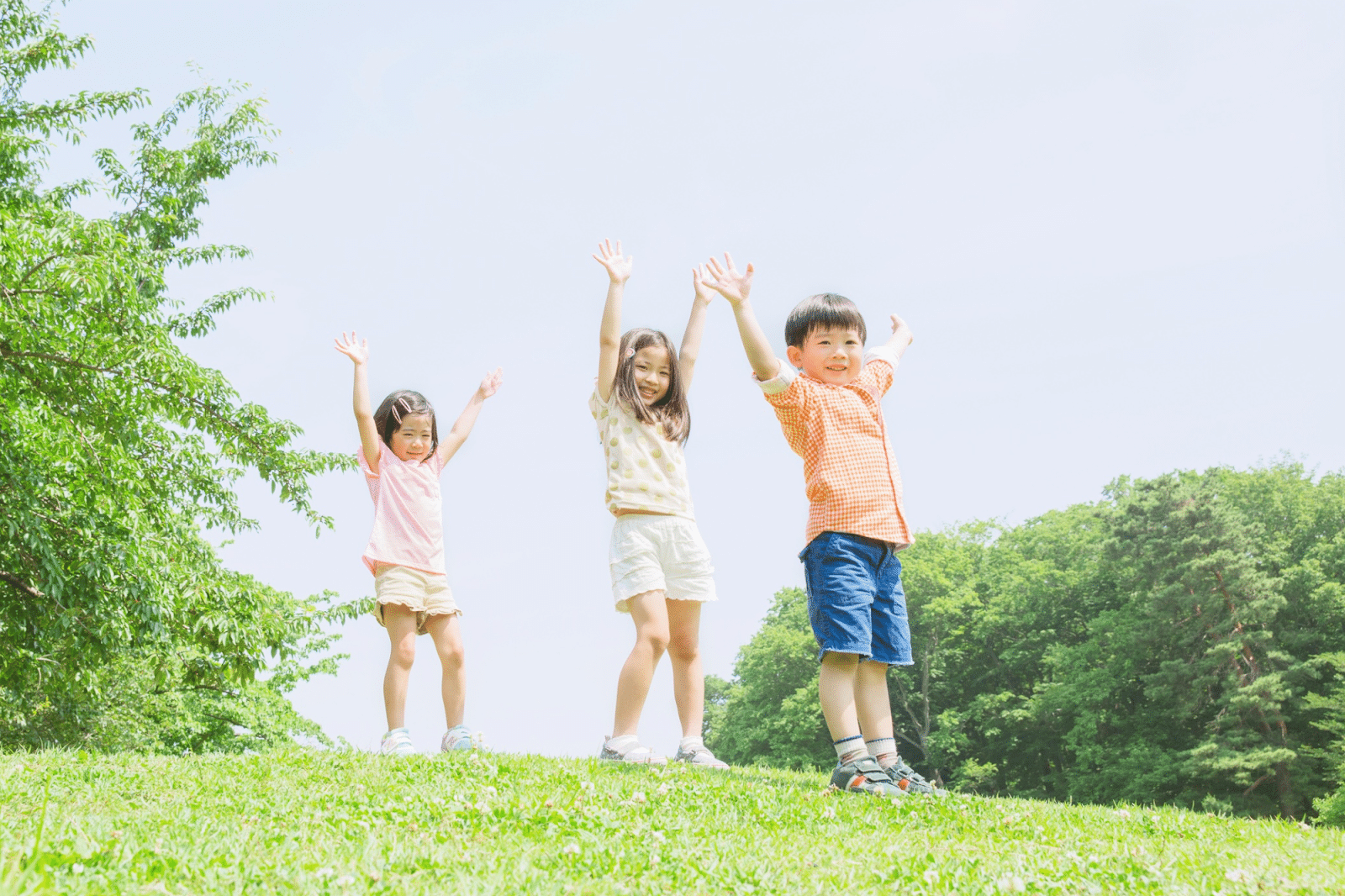 Three kids happily play outside after they fully recover from a viral lung infection.